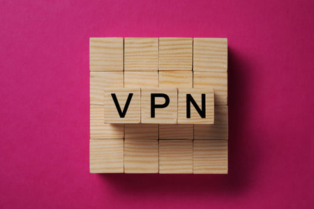 Wooden cubes with acronym VPN on crimson background, top viewの写真素材