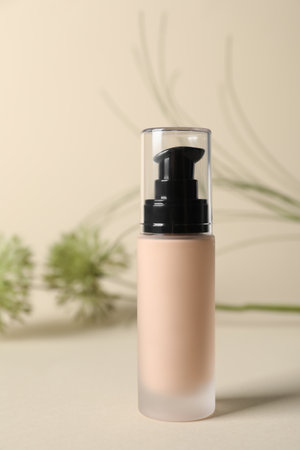 Bottle of skin foundation on beige background. Makeup productの写真素材
