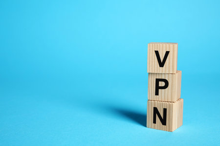 Wooden cubes with acronym VPN on light blue background, space for textの写真素材