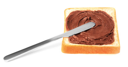 Tasty toast with chocolate paste and knife on white backgroundの写真素材