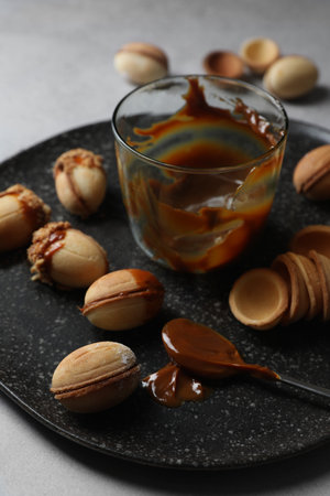 Delicious walnut shaped cookies with condensed milk on gray table, closeupの写真素材