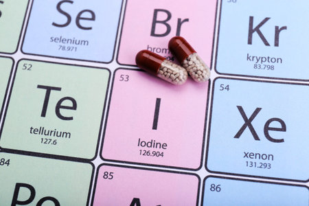 Symbol Iodine and pills on periodic table of elements, top viewの写真素材