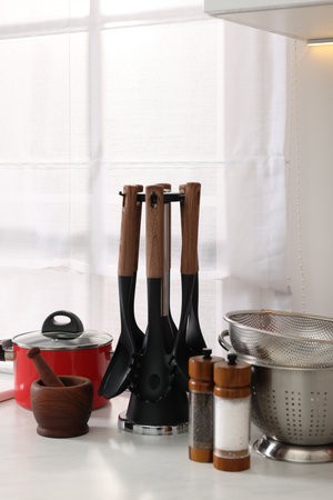 Set of different utensils on countertop in kitchenの写真素材