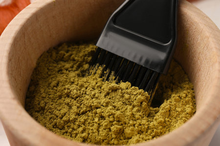 Henna powder and brush in bowl, closeup. Natural hair coloringの写真素材