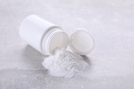 Bottle of sweet powder on light gray table