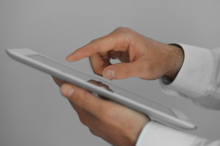 Closeup view of man using new tablet indoors