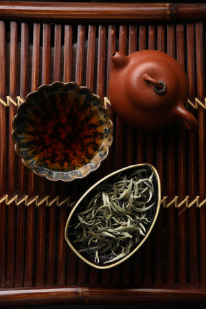 Aromatic Baihao Yinzhen tea and teapot on wooden tray, flat lay. traditional ceremonyの写真素材