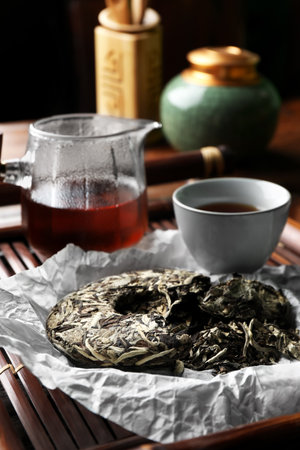 Broken disc shaped pu-erh tea on wooden tray, closeup. traditional ceremonyの写真素材