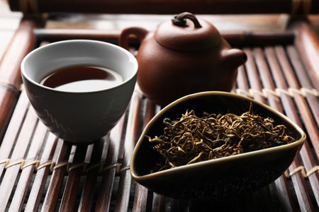 Aromatic Dianhong tea on wooden tray, closeup. traditional ceremonyの写真素材