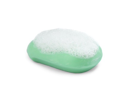 Soap bar with fluffy foam on white backgroundの写真素材