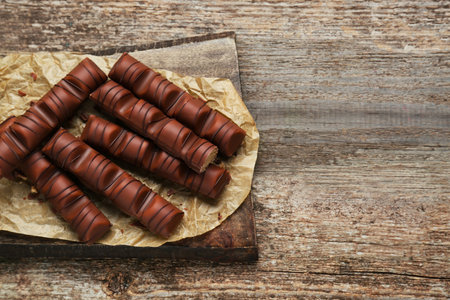 Tasty chocolate bars on wooden table, top view. Space for textの写真素材