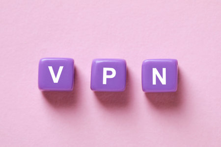 Lilac plastic beads with acronym VPN on pale pink background, flat layの写真素材