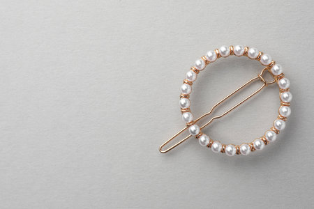 Elegant pearl hair clip on white background, top view. Space for textの写真素材