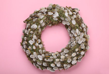 Wreath made of beautiful willow flowers on pink background, top viewの写真素材