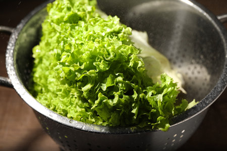 Fresh lettuce on brown table, closeup. Salad greensの写真素材