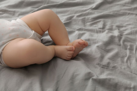 Little baby on bed, closeup. Space for text