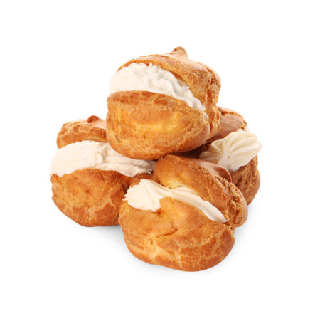 Delicious profiteroles with cream filling on white backgroundの写真素材
