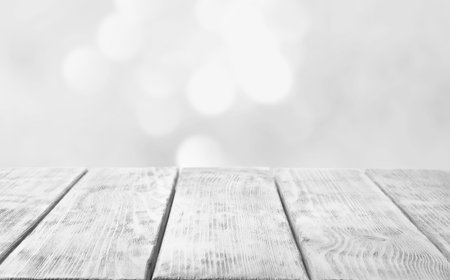Empty white wooden surface against blurred background, bokeh effect. Space for designの写真素材