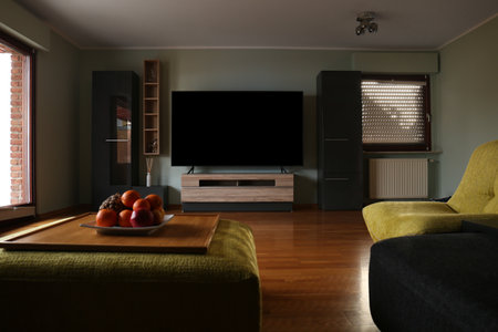 Stylish room with beautiful furniture and TV set on table. Interior designの写真素材