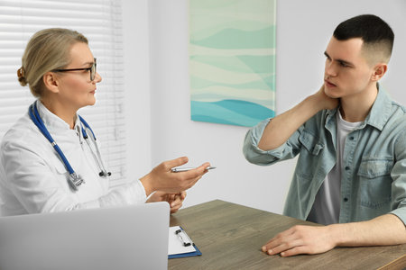 Professional doctor working with patient in clinicの写真素材