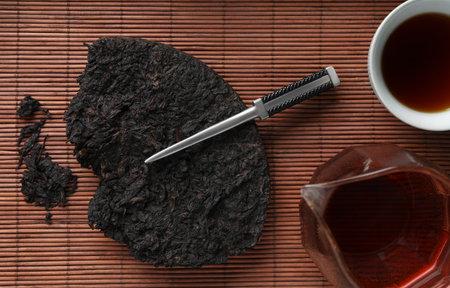 Flat lay composition with pu-erh tea on bamboo mat