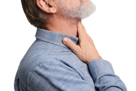 Senior man suffering from sore throat on white background, closeup. Cold symptomsの写真素材