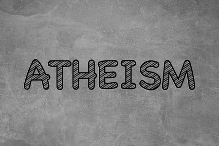 Word Atheism on gray stone surface. Philosophical or religious positionの写真素材