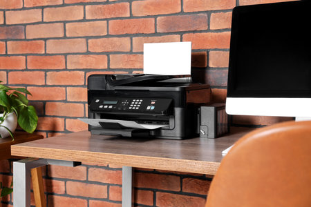 Stylish workplace with modern computer and printer at home