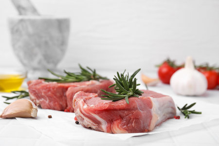 Fresh raw meat with rosemary on table, closeupの写真素材