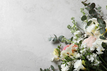 Bouquet of beautiful flowers on light gray table, top view. Space for textの写真素材