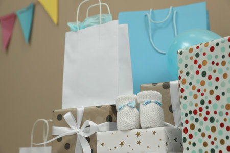 Baby shower party. Booties, many gift boxes and bags indoorsの写真素材