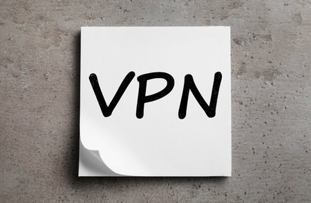 Paper sheet with acronym VPN (Virtual Private Network) on gray table, top viewの写真素材