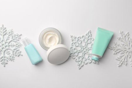 Winter skin care. Flat lay composition with hand cream and cosmetic products on white backgroundの写真素材