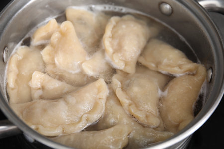 Boiling delicious dumplings (varenyky) in pot, closeupの写真素材