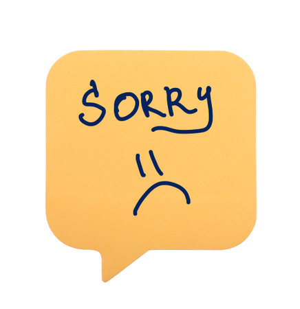 Apology. Sticky note with the word Sorry and drawn sad face on white backgroundの写真素材