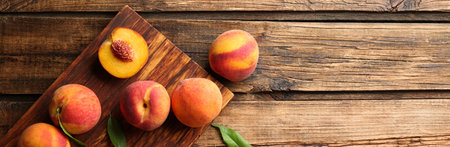 Fresh ripe peaches on wooden table, top view. Banner design with space for text