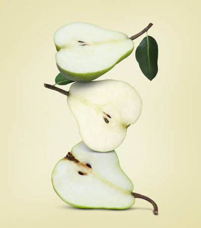 Cut fresh ripe pears on beige background