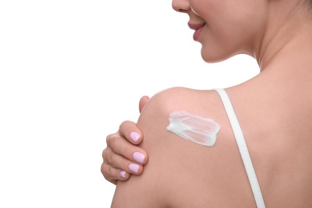 Woman with smear of body cream on her shoulder against white background, closeupの写真素材