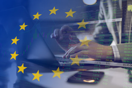 Stock exchange. Multiple exposure with European flag, data, graph and man using laptop