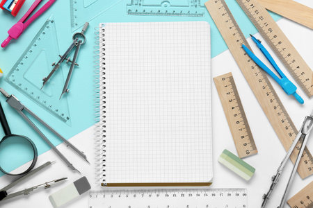 Flat lay composition with different rulers and notebook on color backgroundの写真素材