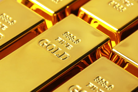 Many shiny gold bars as background, closeup