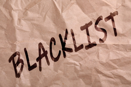 Black word Blacklist on crumpled beige paperの写真素材