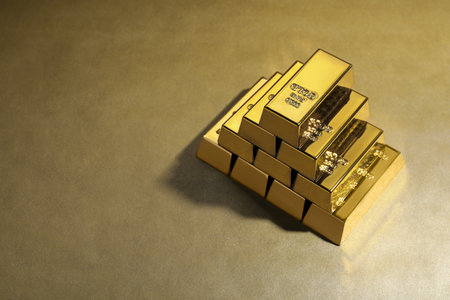 Many shiny gold bars on color background. Space for text