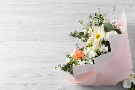 Bouquet of beautiful flowers on white wooden table, top view. Space for textの写真素材