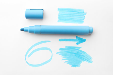 Different strokes, circle, arrow drawn with light blue marker and highlighter on white background, top viewの写真素材