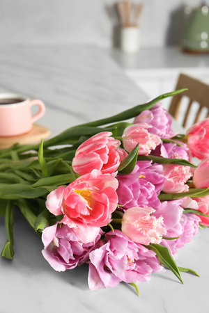Beautiful bouquet of colorful tulip flowers on white table indoorsの写真素材