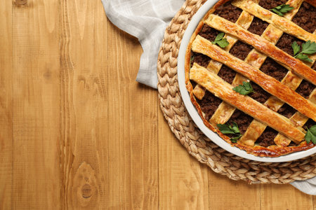 Freshly baked meat pie on wooden table, top view. Space for textの写真素材
