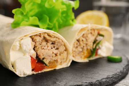 Delicious tortilla wraps with tuna on gray table, closeup. Space for textの写真素材