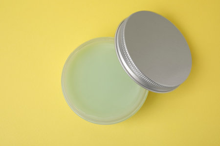 Jar of petroleum jelly on yellow background, top viewの写真素材