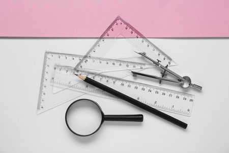 Flat lay composition with different rulers, pencil and compass on color backgroundの写真素材